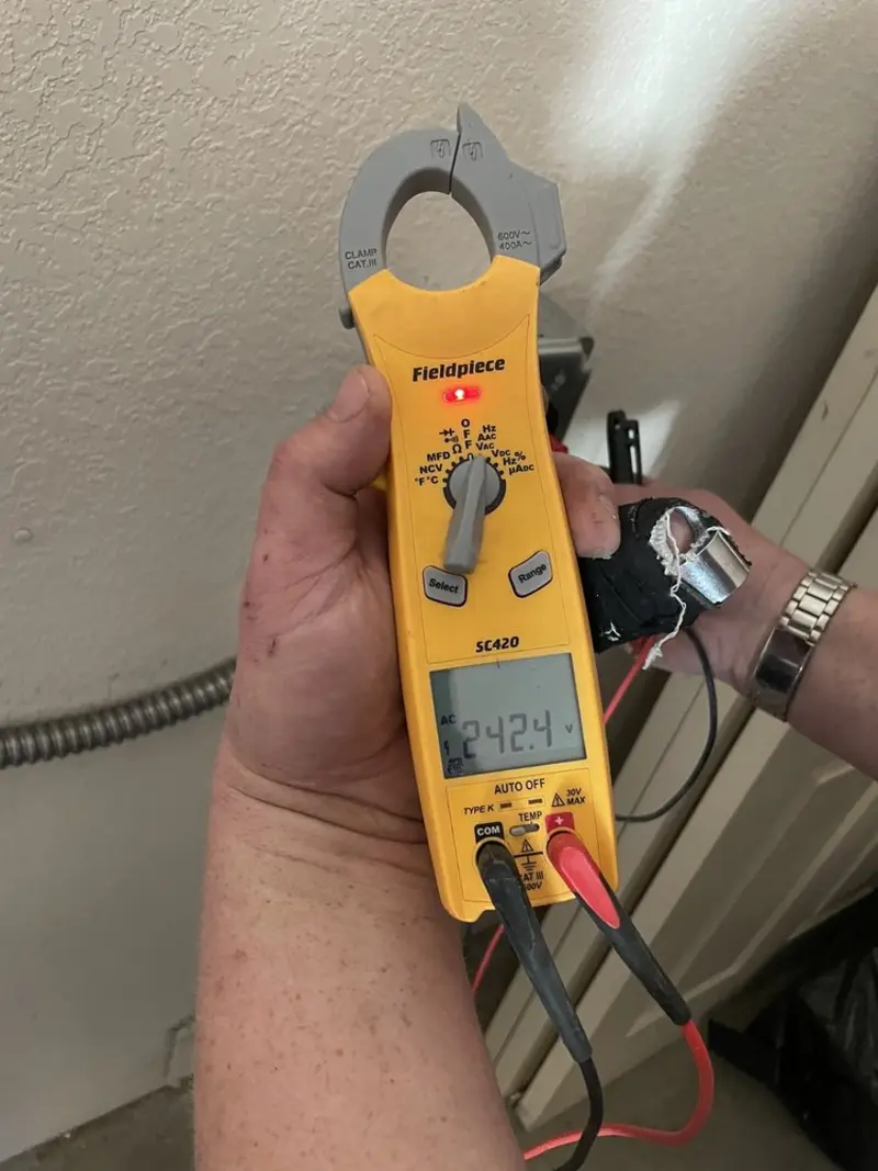 Voltage testing with clamp meter during Electrical Installation Services in Conway